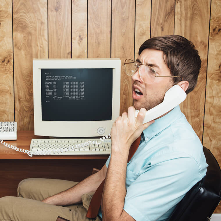 Man holding phone looking confused